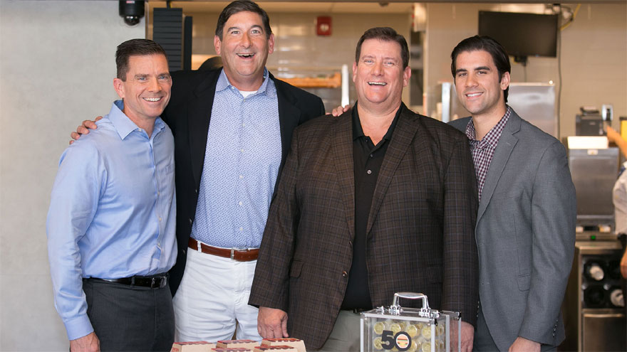 Mike (saco azul) y otros miembros de la familia Delligatti junto a Steve Easterbrook, CEO de McDonald’s, celebrando el aniversario del Big Mac